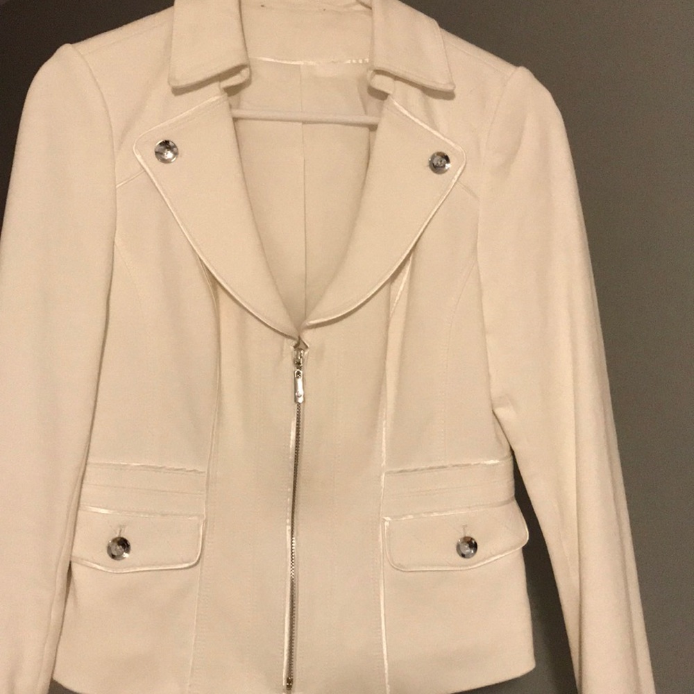 White jacket with silver zippers, two pockets.